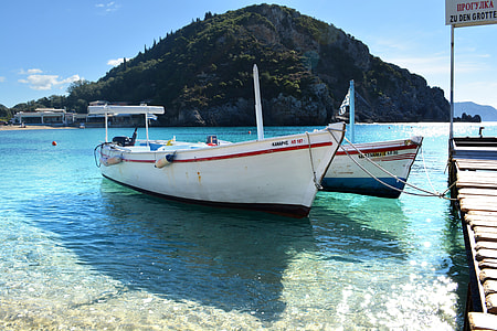 white motorboat at dock thumbnail