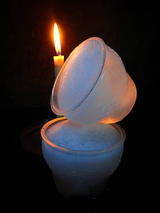 lighted candle in behind glass cups thumbnail