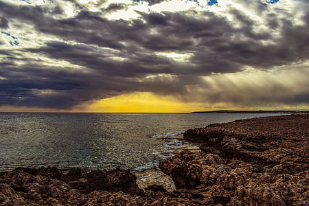 seashore under nimbus clouds thumbnail