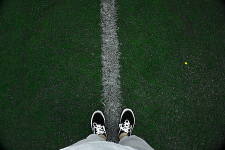 low angle photography of person wearing black-and-white low-top sneakers thumbnail