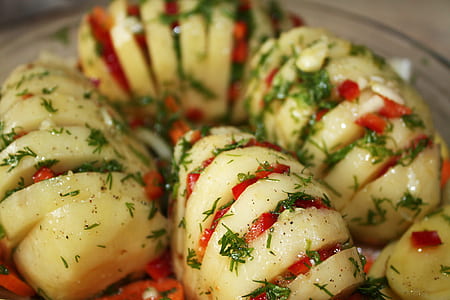 cut cooked potato dish with topped minced red bellpepper thumbnail