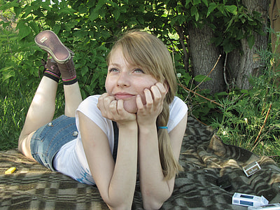 woman lying on blanket while smiling thumbnail