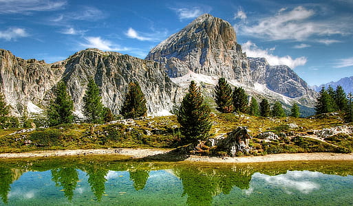 mountain near body of water during daytime thumbnail