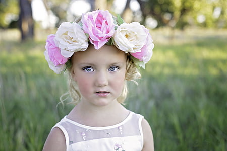 closeup photo of girl wearing white dress and floral headband thumbnail