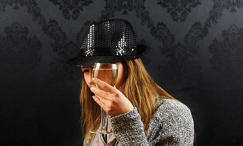 woman holding wine glass standing near wall thumbnail