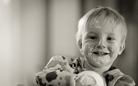 baby in animal-print top grayscale photo thumbnail