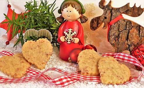 girl and moose figure beside brown cookies thumbnail