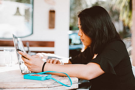 Woman Using Smartphone and Laptop thumbnail