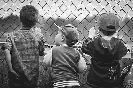 grayscale photograph of tree child holding fence thumbnail