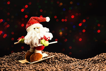 Santa Claus plush toy on top of coffee beans thumbnail