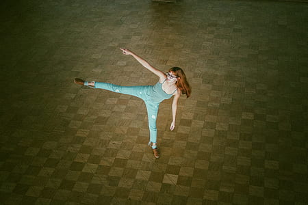 woman lifting her right foot and arm inside room thumbnail
