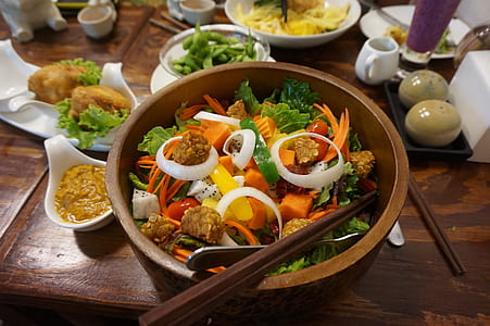 salad dish on brown wooden bowl with chopstick thumbnail