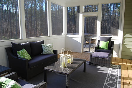 room with black area rug and black sofa set thumbnail