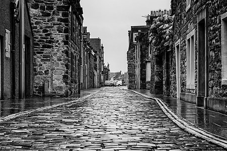 grayscale photo of concrete street in village thumbnail