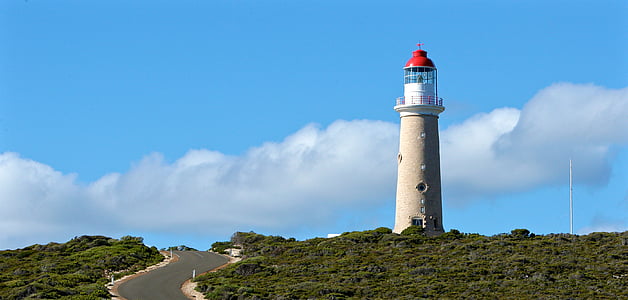 lighthouse tower under blue sky and white clouds during daytime thumbnail