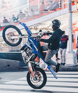 man riding blue and white Yamaha dirt bike thumbnail