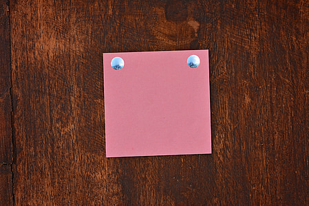 red sticky note on brown surface thumbnail