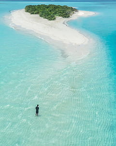 man standing on island during daytime thumbnail