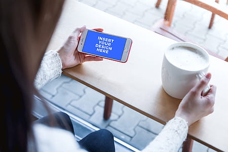 Girl in the cafe with new iPhone 7 RED. Free PSD Mockup thumbnail
