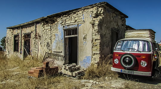 red bus beside concrete house thumbnail