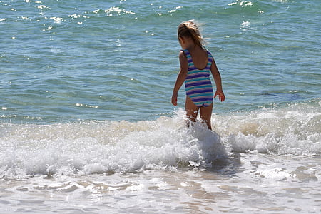 girl walking on beach shore thumbnail
