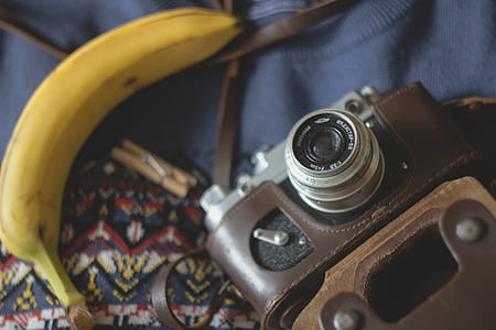 grey and black camera beside yellow banana thumbnail