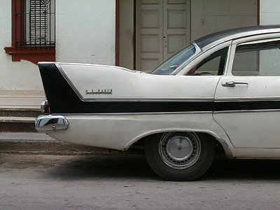 parked classic white car near building thumbnail