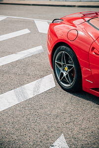 Rear side view of a red convertible sports car with alloy wheels thumbnail