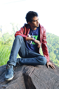 man in red jacket on rock thumbnail