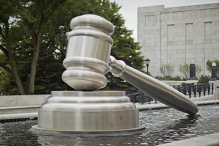 closeup of gray gavel monument near water fountain thumbnail