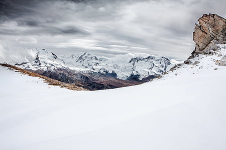 brown mountain covered with snow at daytime thumbnail