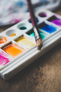 brown paintbrush on white watercolor palette thumbnail