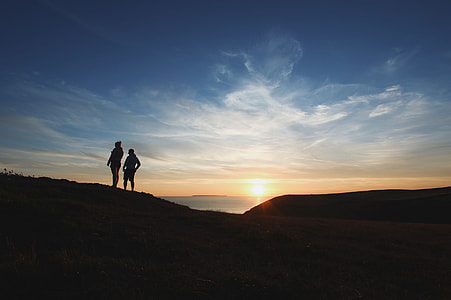 silhouette of person standing on mountain thumbnail