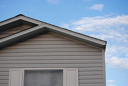 grey wooden house under blue cloudy sky thumbnail