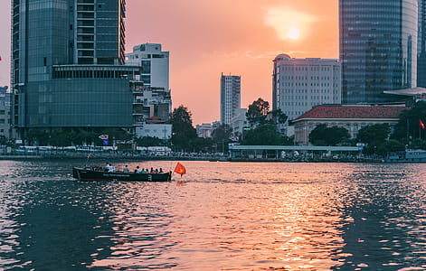 People Riding on Boat Sailing Along Calm Waters thumbnail