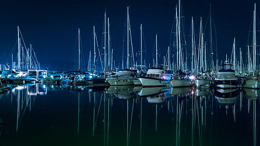 white wooden boats on body of water thumbnail