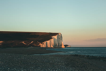 stone formation beside body of water thumbnail