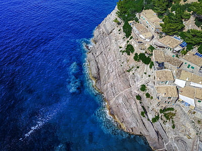 aerial photography of houses near body of water thumbnail