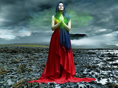 photo of woman wearing red dress and blue hijab headdress praying thumbnail