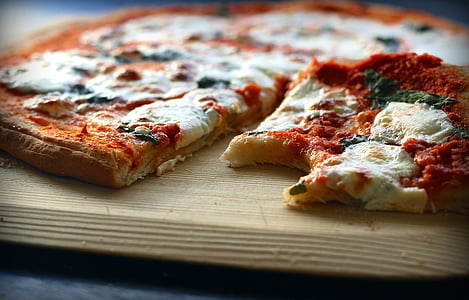 cooked pizza on brown wooden tray thumbnail