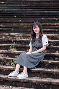 Woman Sitting on Gray Concrete Stair thumbnail