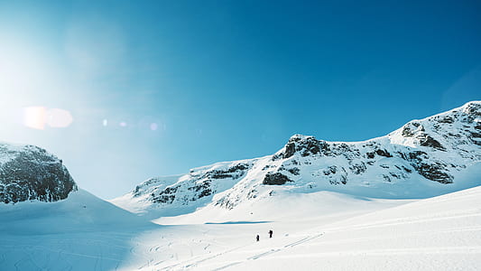 two person walking on snow across the mountain thumbnail
