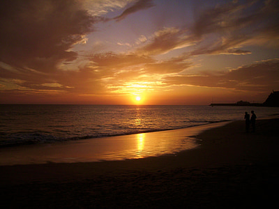 silhouette of two person on seashore thumbnail