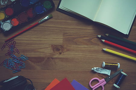 water color palette beside red brush and clips on brown parquet floor thumbnail