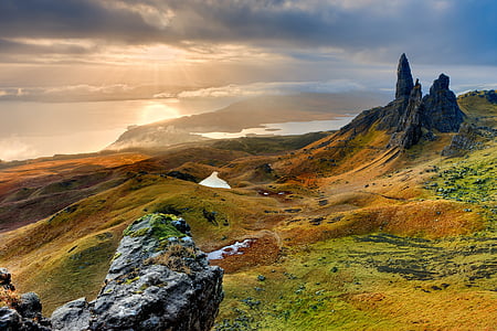 landscape photography of green mountain near body of water thumbnail