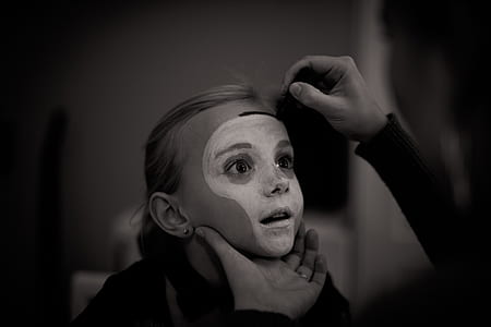 sepia photography of girl face with white paint thumbnail