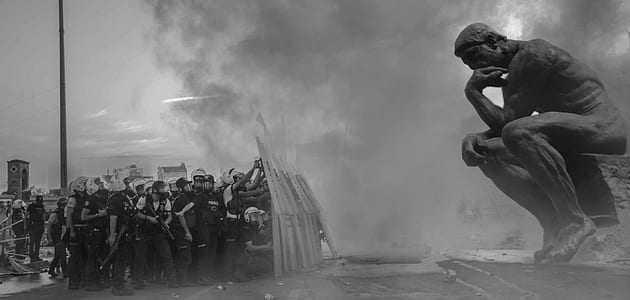 grayscale photography of riot police in front of The Thinker statue thumbnail