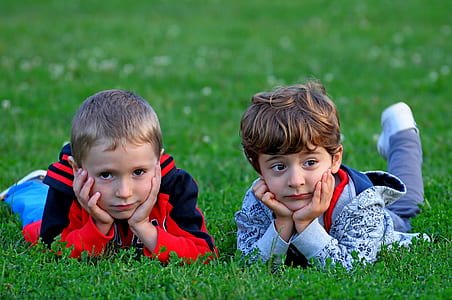 two boys lying on grass thumbnail