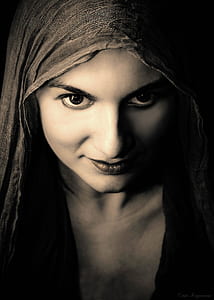 photo of woman in gray headscarf and black top thumbnail