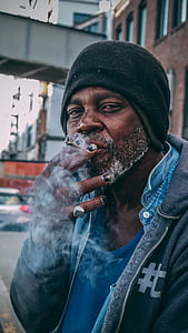 man smoking beside road thumbnail